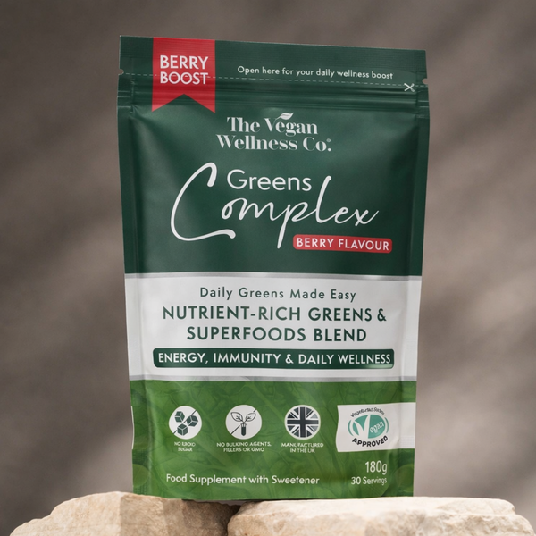 Package of The Vegan Wellness Co. Greens Complex with berry flavor on a neutral background