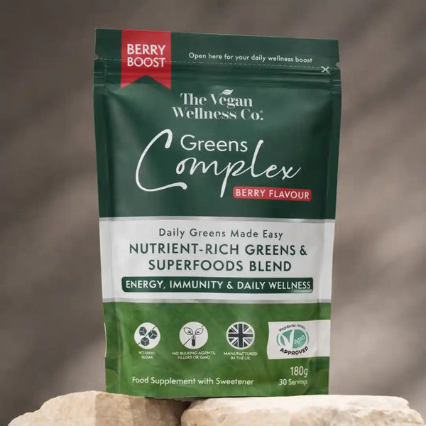 Package of The Vegan Wellness Co. Greens Complex with berry flavor on a neutral background