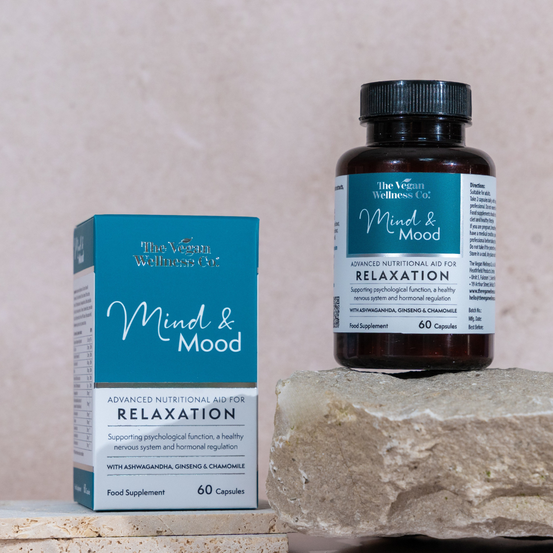 Supplement bottle and packaging labeled 'Mind & Mood' on a stone surface with a neutral background
