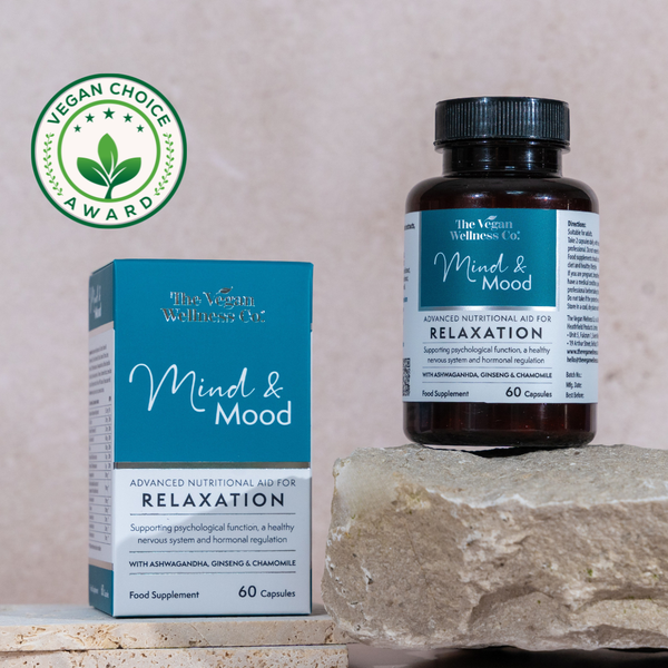 Vegan Wellness Co. Mind & Mood supplement bottle and packaging on a stone surface with a beige background.