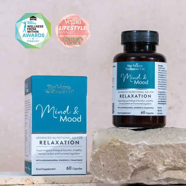 Supplement bottle and packaging of 'The Vegan Wellness Co. Mind & Mood' on a stone surface with awards logos.